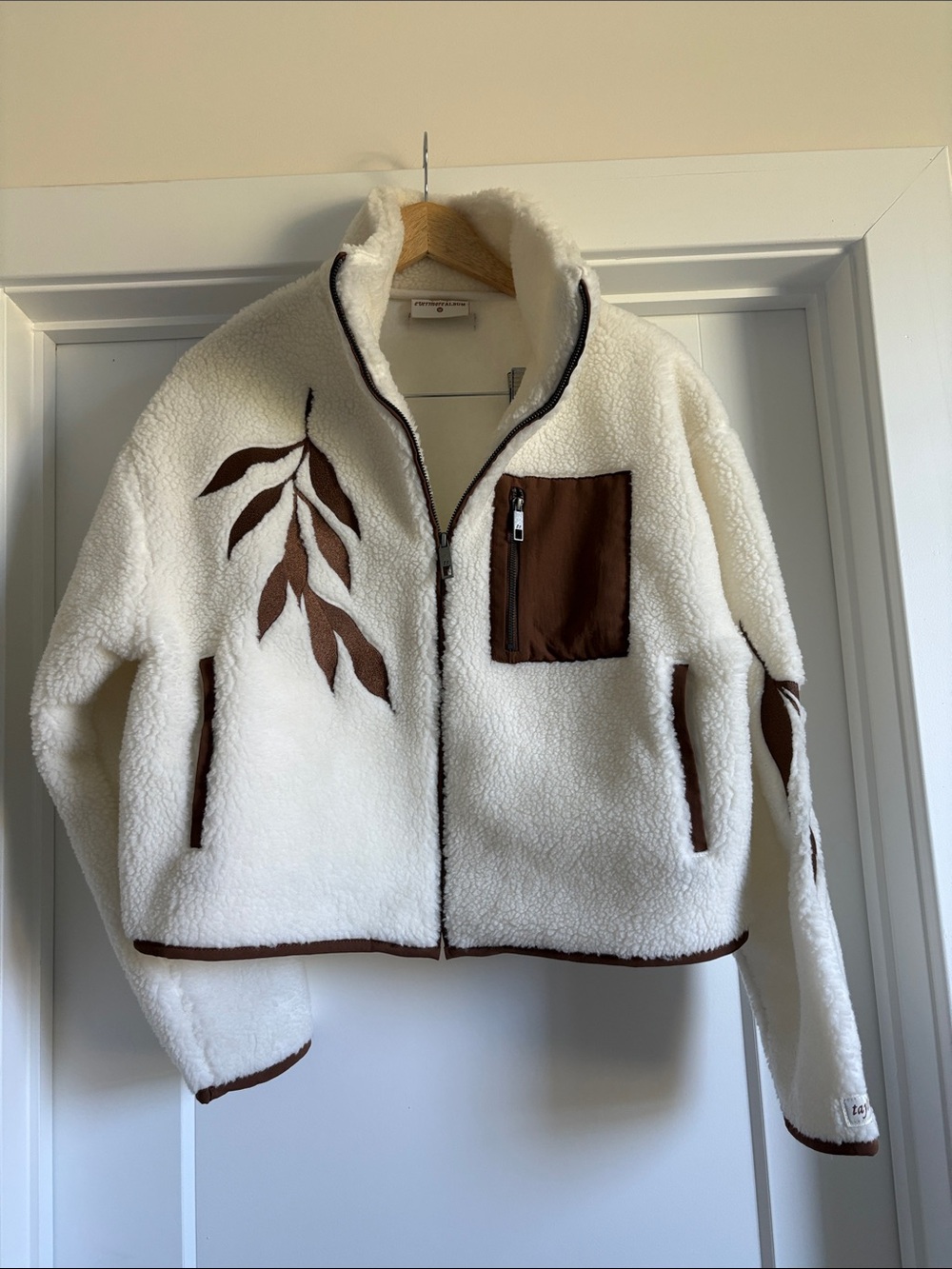Taylor Swift evermore Cream Sherpa Jacket with Brown Trim and Leaf Design